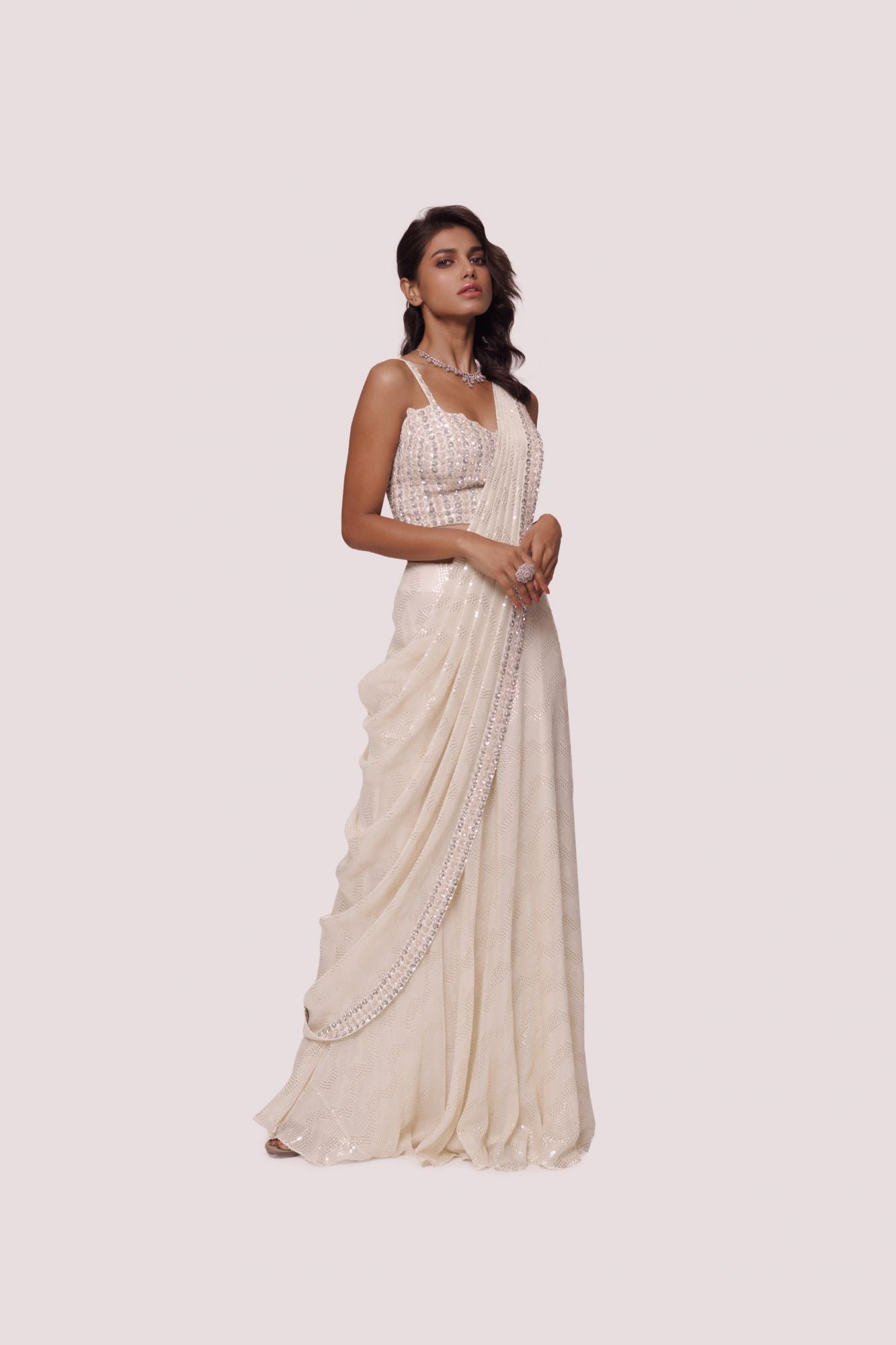 Shop offwhite sequinned chikankari saree. Make a fashion statement on festive occasions and weddings with designer sarees, designer suits, Indian dresses, Anarkali suits, palazzo suits, designer gowns, sharara suits, and embroidered sarees from Pure Elegance Indian fashion store in the USA.