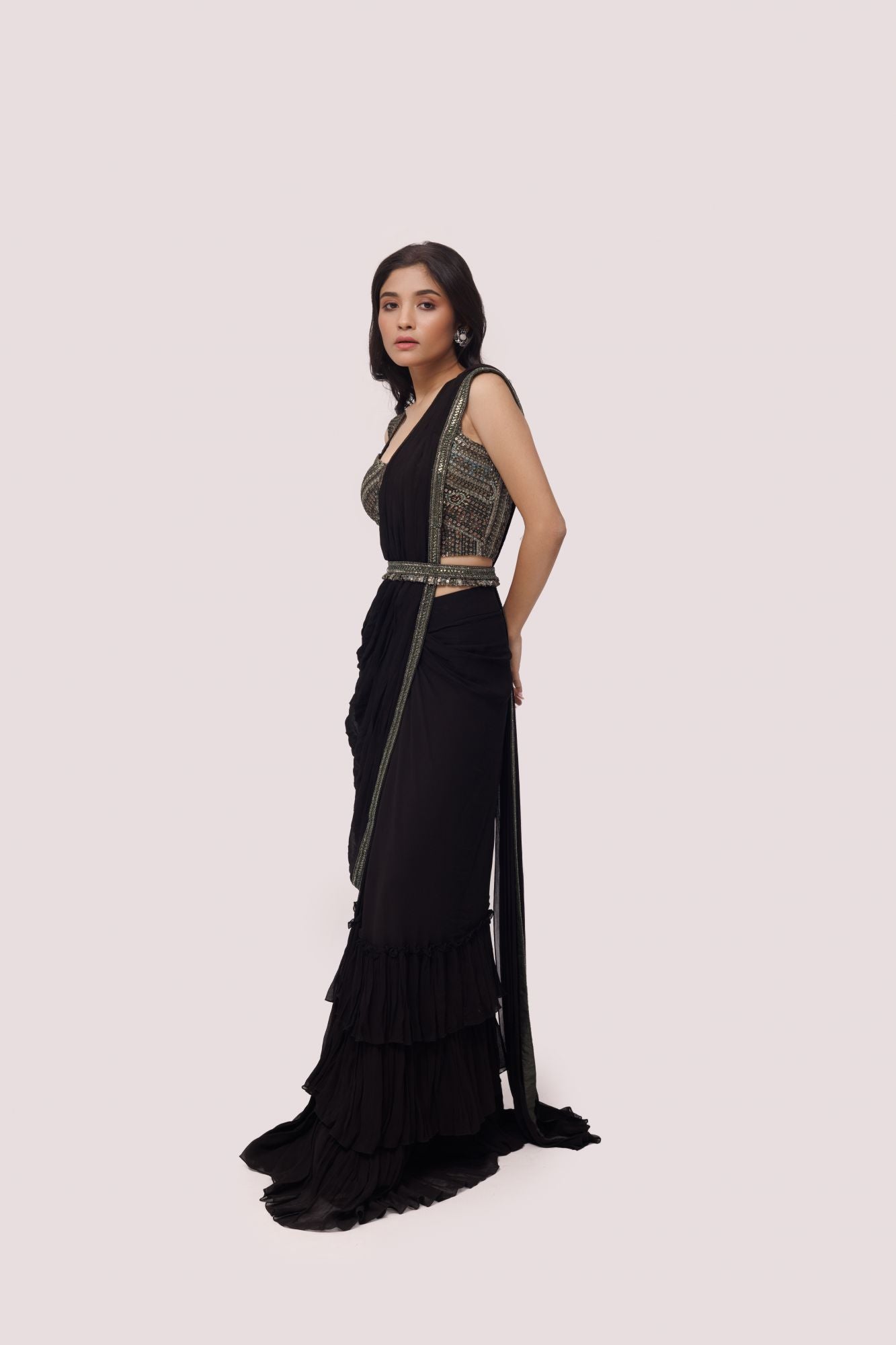 Shop black ruffle pre stiched saree set. Make a fashion statement on festive occasions and weddings with designer sarees, designer suits, Indian dresses, Anarkali suits, palazzo suits, designer gowns, sharara suits, and embroidered sarees from Pure Elegance Indian fashion store in the USA.