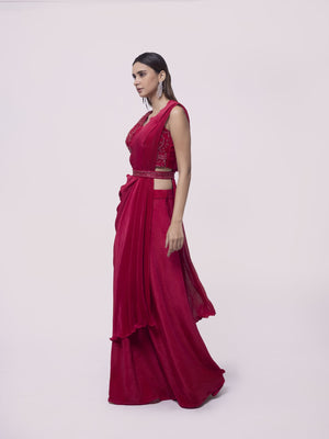 Shop a red drape saree set featuring mirror work. Make a fashion statement on festive occasions and weddings with designer sarees, designer suits, Indian dresses, Anarkali suits, palazzo suits, designer gowns, sharara suits, and embroidered sarees from Pure Elegance Indian fashion store in the USA.