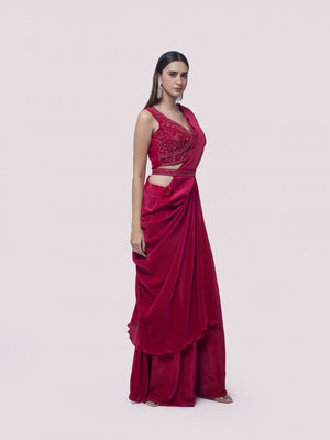 Shop a red drape saree set featuring mirror work. Make a fashion statement on festive occasions and weddings with designer sarees, designer suits, Indian dresses, Anarkali suits, palazzo suits, designer gowns, sharara suits, and embroidered sarees from Pure Elegance Indian fashion store in the USA.