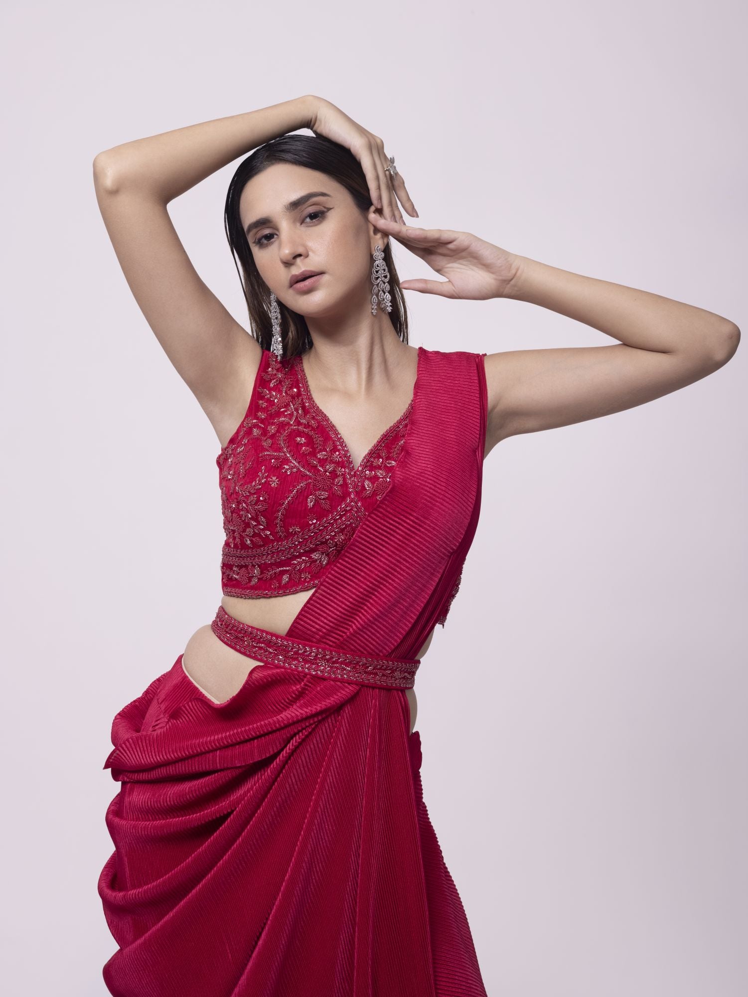 Shop a red drape saree set featuring mirror work. Make a fashion statement on festive occasions and weddings with designer sarees, designer suits, Indian dresses, Anarkali suits, palazzo suits, designer gowns, sharara suits, and embroidered sarees from Pure Elegance Indian fashion store in the USA.