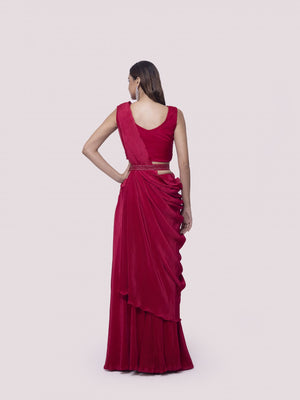 Shop a red drape saree set featuring mirror work. Make a fashion statement on festive occasions and weddings with designer sarees, designer suits, Indian dresses, Anarkali suits, palazzo suits, designer gowns, sharara suits, and embroidered sarees from Pure Elegance Indian fashion store in the USA.