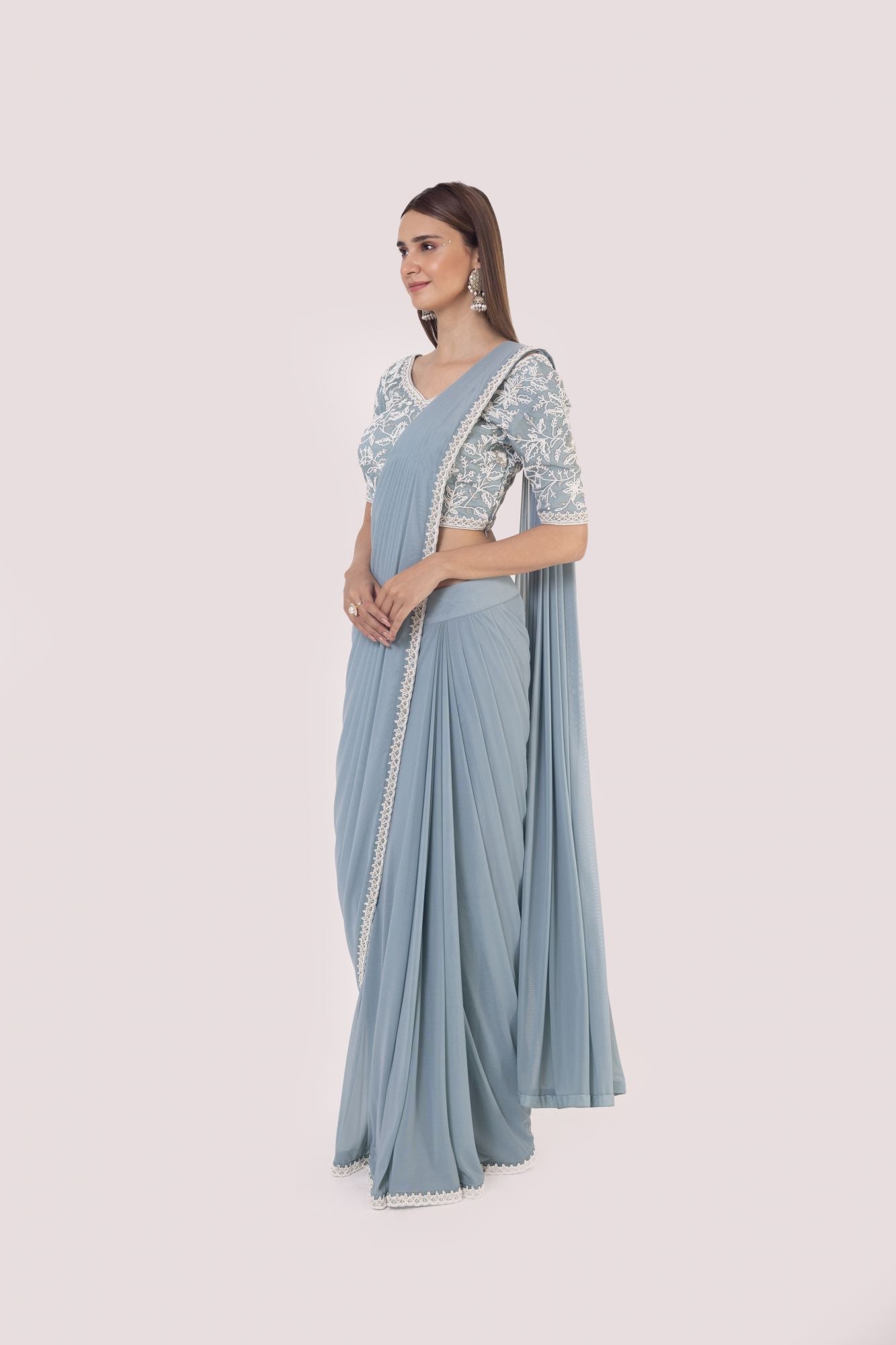 Shop a blue drape saree set embedded with moti work. Make a fashion statement on festive occasions and weddings with designer sarees, designer suits, Indian dresses, Anarkali suits, palazzo suits, designer gowns, sharara suits, and embroidered sarees from Pure Elegance Indian fashion store in the USA.
