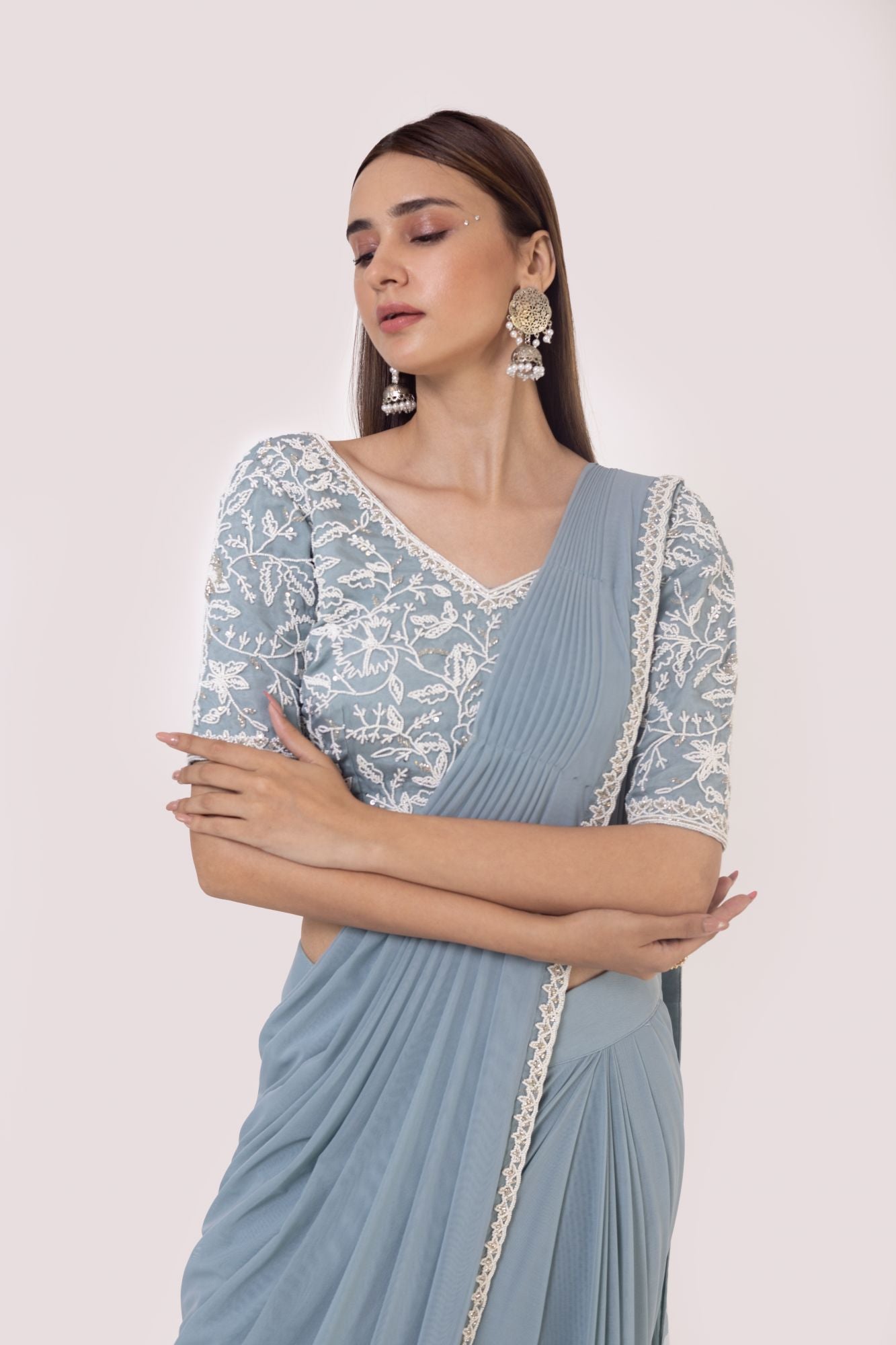 Shop a blue drape saree set embedded with moti work. Make a fashion statement on festive occasions and weddings with designer sarees, designer suits, Indian dresses, Anarkali suits, palazzo suits, designer gowns, sharara suits, and embroidered sarees from Pure Elegance Indian fashion store in the USA.