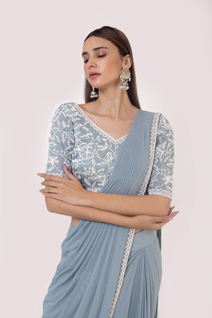 Shop a blue drape saree set embedded with moti work. Make a fashion statement on festive occasions and weddings with designer sarees, designer suits, Indian dresses, Anarkali suits, palazzo suits, designer gowns, sharara suits, and embroidered sarees from Pure Elegance Indian fashion store in the USA.