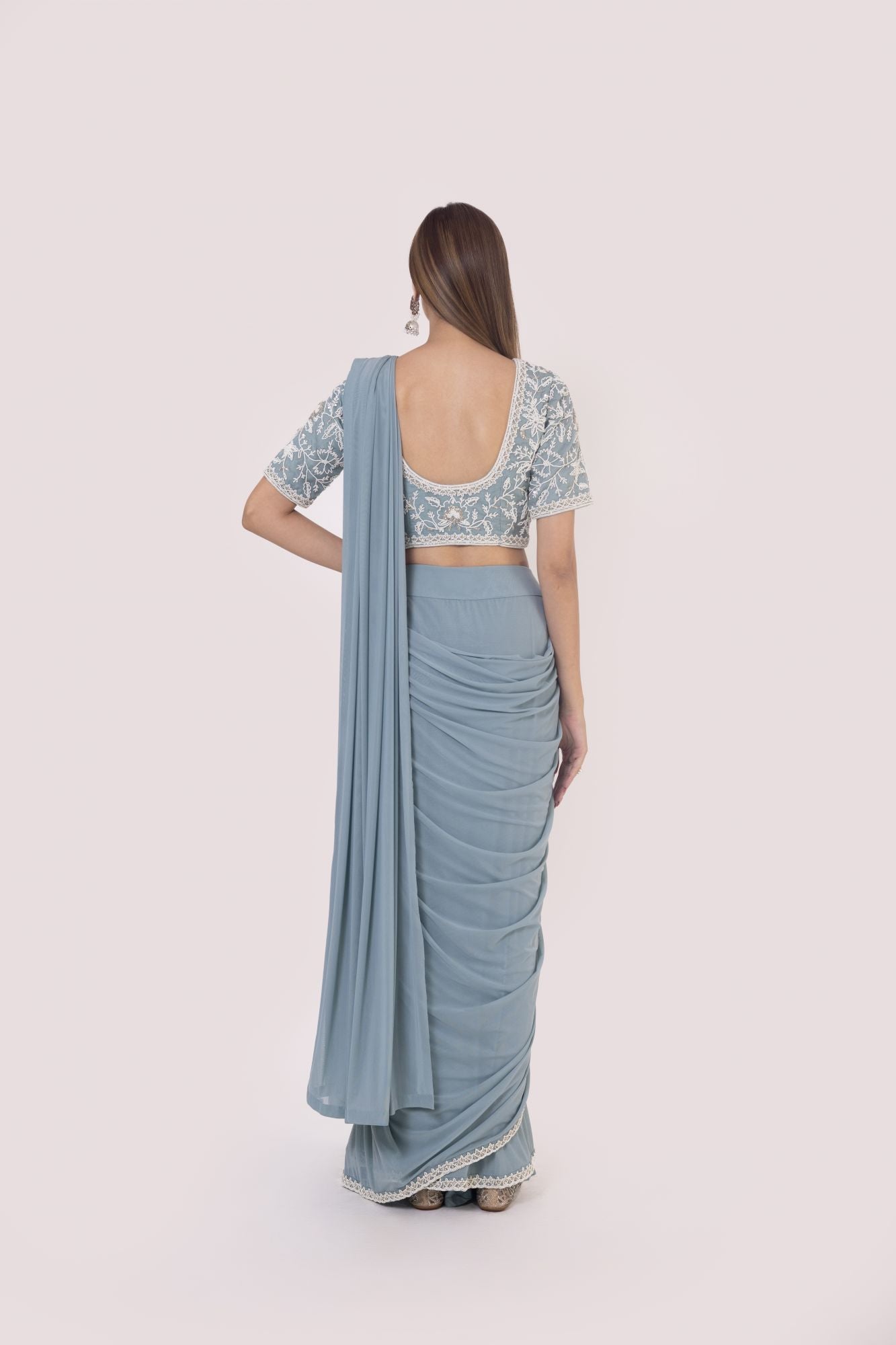 Shop a blue drape saree set embedded with moti work. Make a fashion statement on festive occasions and weddings with designer sarees, designer suits, Indian dresses, Anarkali suits, palazzo suits, designer gowns, sharara suits, and embroidered sarees from Pure Elegance Indian fashion store in the USA.