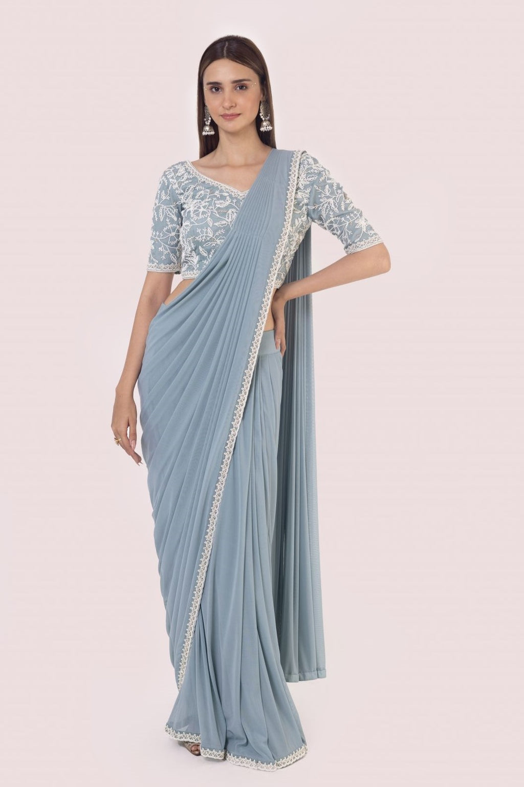 Shop a blue drape saree set embedded with moti work. Make a fashion statement on festive occasions and weddings with designer sarees, designer suits, Indian dresses, Anarkali suits, palazzo suits, designer gowns, sharara suits, and embroidered sarees from Pure Elegance Indian fashion store in the USA.