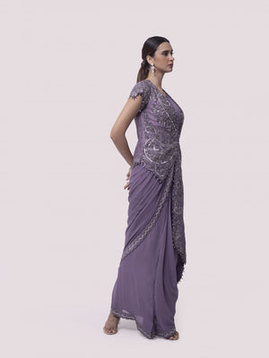 Shop lilac georgette pre-stitched saree with an embroidered jacket. Make a fashion statement on festive occasions and weddings with designer sarees, designer suits, Indian dresses, Anarkali suits, palazzo suits, designer gowns, sharara suits, and embroidered sarees from Pure Elegance Indian fashion store in the USA.