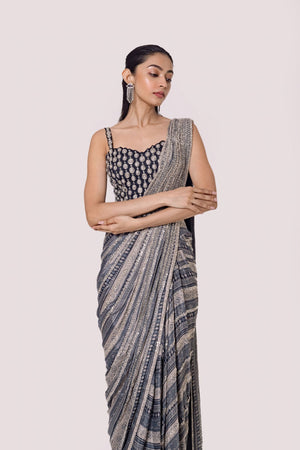 Shop grey Black printed chiffon saree set featuring a strappy blouse and belt. Make a fashion statement on festive occasions and weddings with designer sarees, designer suits, Indian dresses, Anarkali suits, palazzo suits, designer gowns, sharara suits, and embroidered sarees from Pure Elegance Indian fashion store in the USA.