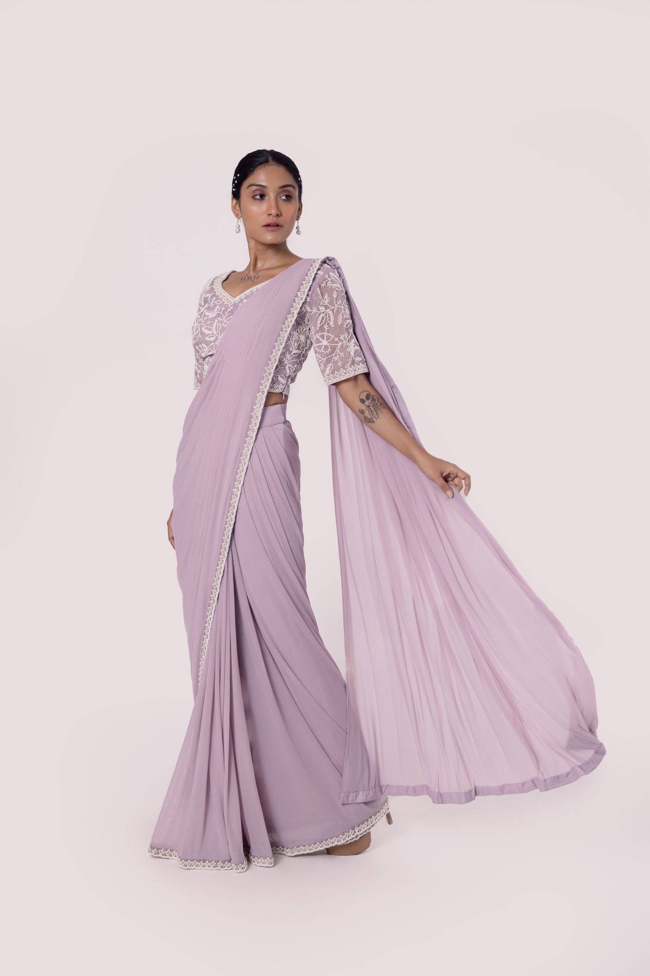 Shop lavender drape saree with embroidered blouse. Make a fashion statement on festive occasions and weddings with designer sarees, designer suits, Indian dresses, Anarkali suits, palazzo suits, designer gowns, sharara suits, and embroidered sarees from Pure Elegance Indian fashion store in the USA.