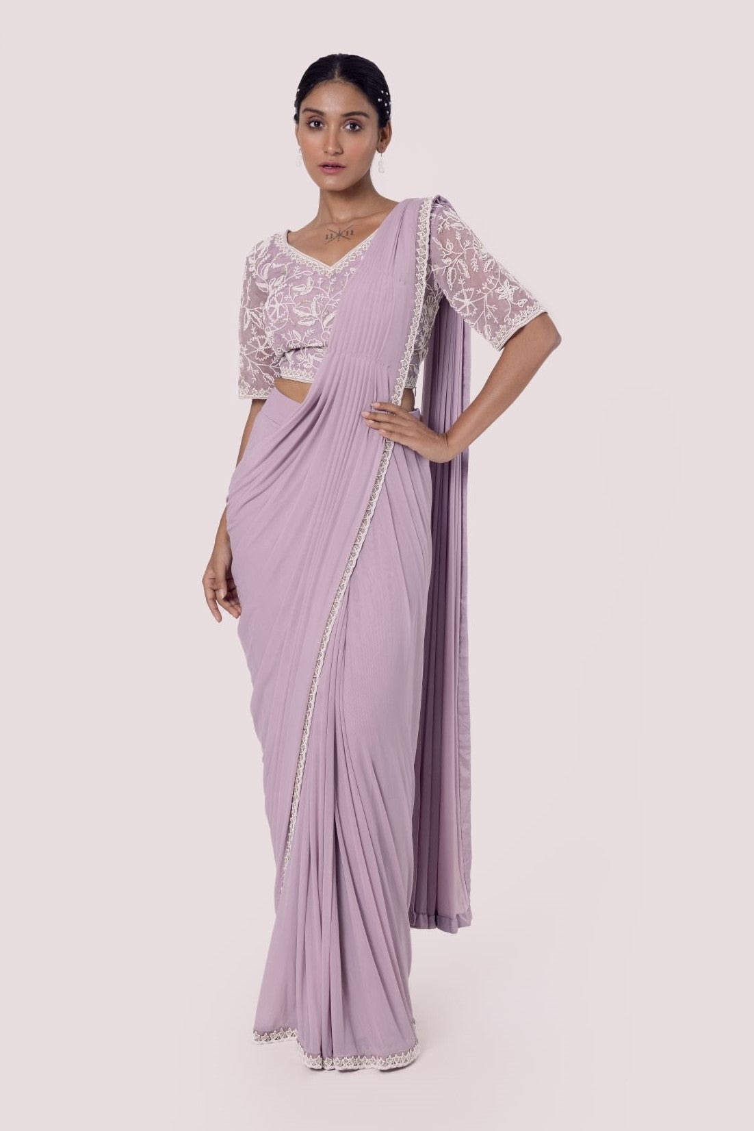 Shop lavender drape saree with embroidered blouse. Make a fashion statement on festive occasions and weddings with designer sarees, designer suits, Indian dresses, Anarkali suits, palazzo suits, designer gowns, sharara suits, and embroidered sarees from Pure Elegance Indian fashion store in the USA.