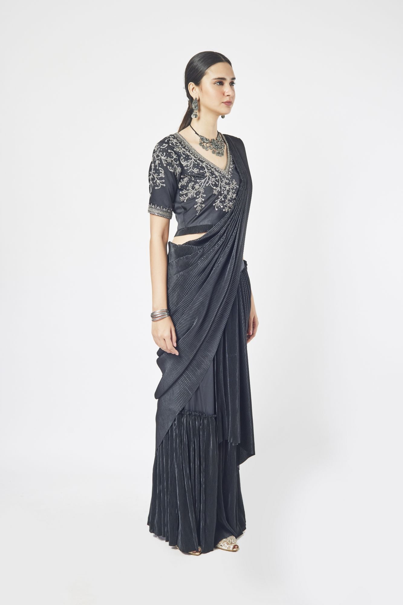 Shop a black drape saree with mirror and cutdana work. Make a fashion statement on festive occasions and weddings with designer sarees, designer suits, Indian dresses, Anarkali suits, palazzo suits, designer gowns, sharara suits, and embroidered sarees from Pure Elegance Indian fashion store in the USA.