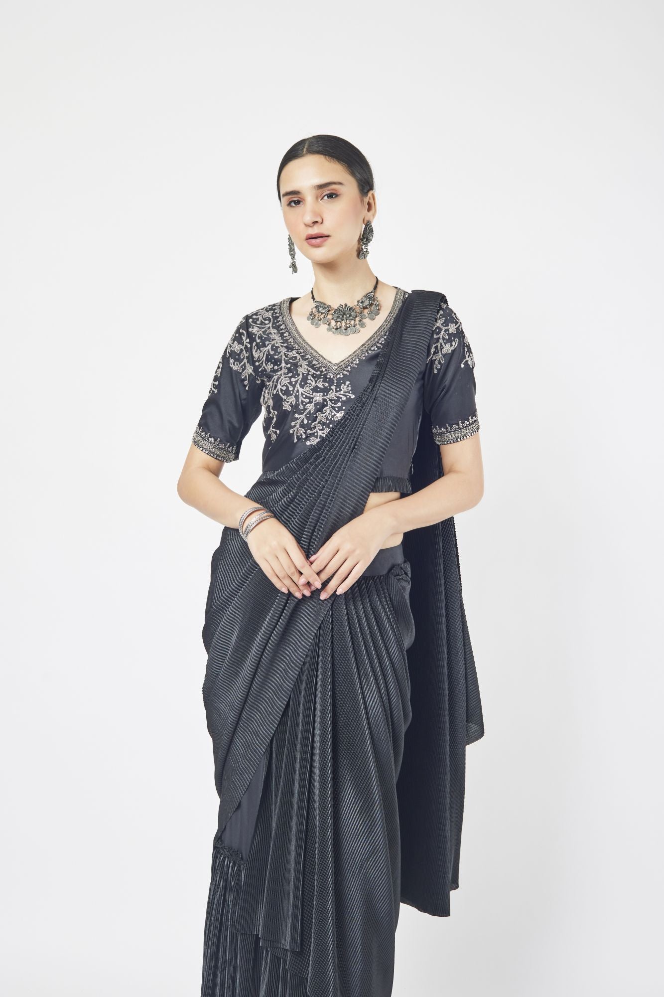 Shop a black drape saree with mirror and cutdana work. Make a fashion statement on festive occasions and weddings with designer sarees, designer suits, Indian dresses, Anarkali suits, palazzo suits, designer gowns, sharara suits, and embroidered sarees from Pure Elegance Indian fashion store in the USA.