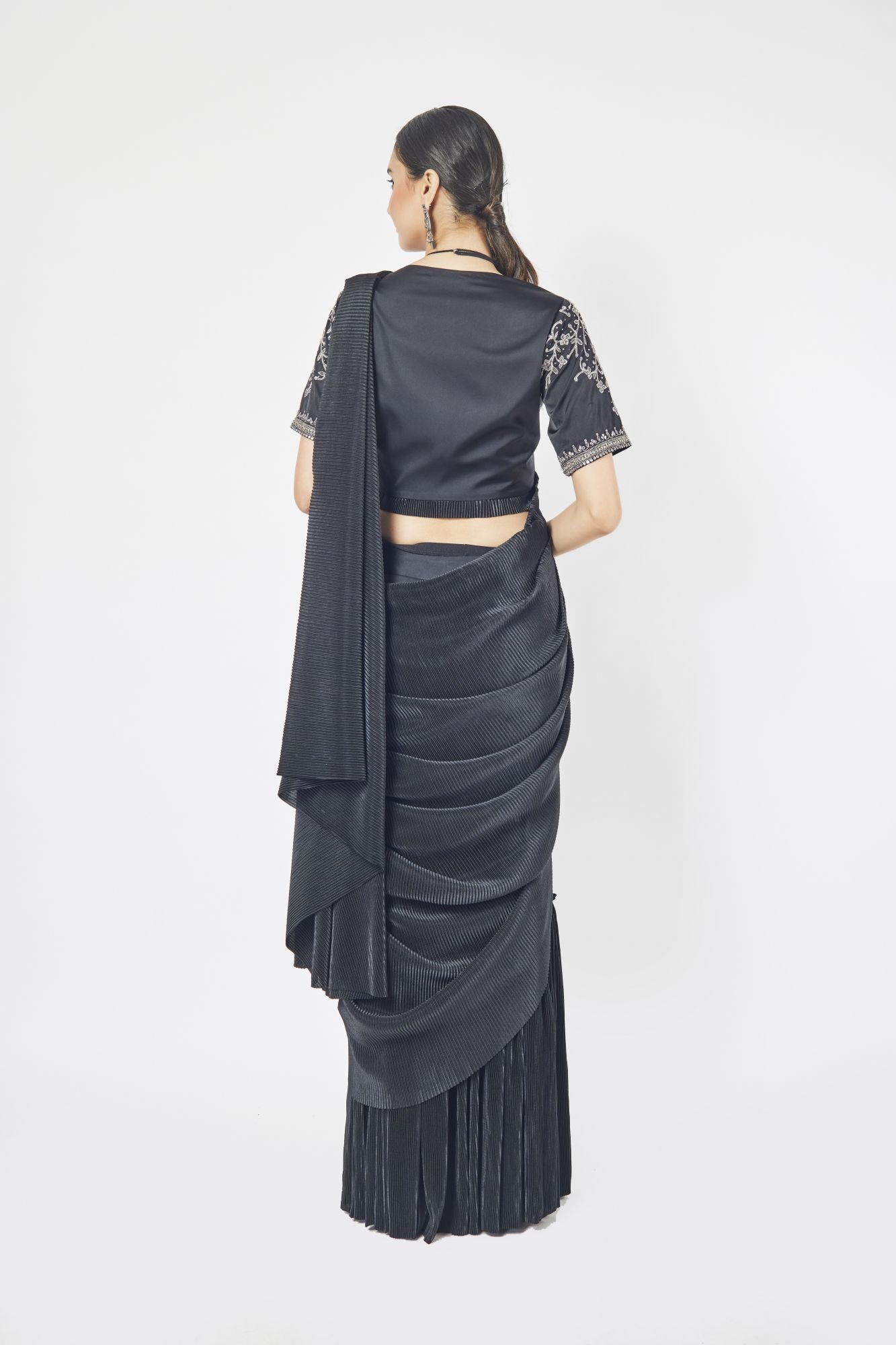 Shop a black drape saree with mirror and cutdana work. Make a fashion statement on festive occasions and weddings with designer sarees, designer suits, Indian dresses, Anarkali suits, palazzo suits, designer gowns, sharara suits, and embroidered sarees from Pure Elegance Indian fashion store in the USA.