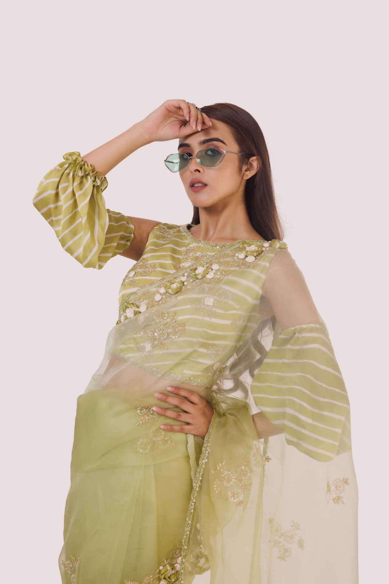 Shop a green organza saree with balloon sleeved blouse. Make a fashion statement on festive occasions and weddings with designer sarees, designer suits, Indian dresses, Anarkali suits, palazzo suits, designer gowns, sharara suits, and embroidered sarees from Pure Elegance Indian fashion store in the USA.