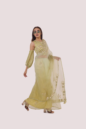 Shop a green organza saree with balloon sleeved blouse. Make a fashion statement on festive occasions and weddings with designer sarees, designer suits, Indian dresses, Anarkali suits, palazzo suits, designer gowns, sharara suits, and embroidered sarees from Pure Elegance Indian fashion store in the USA.