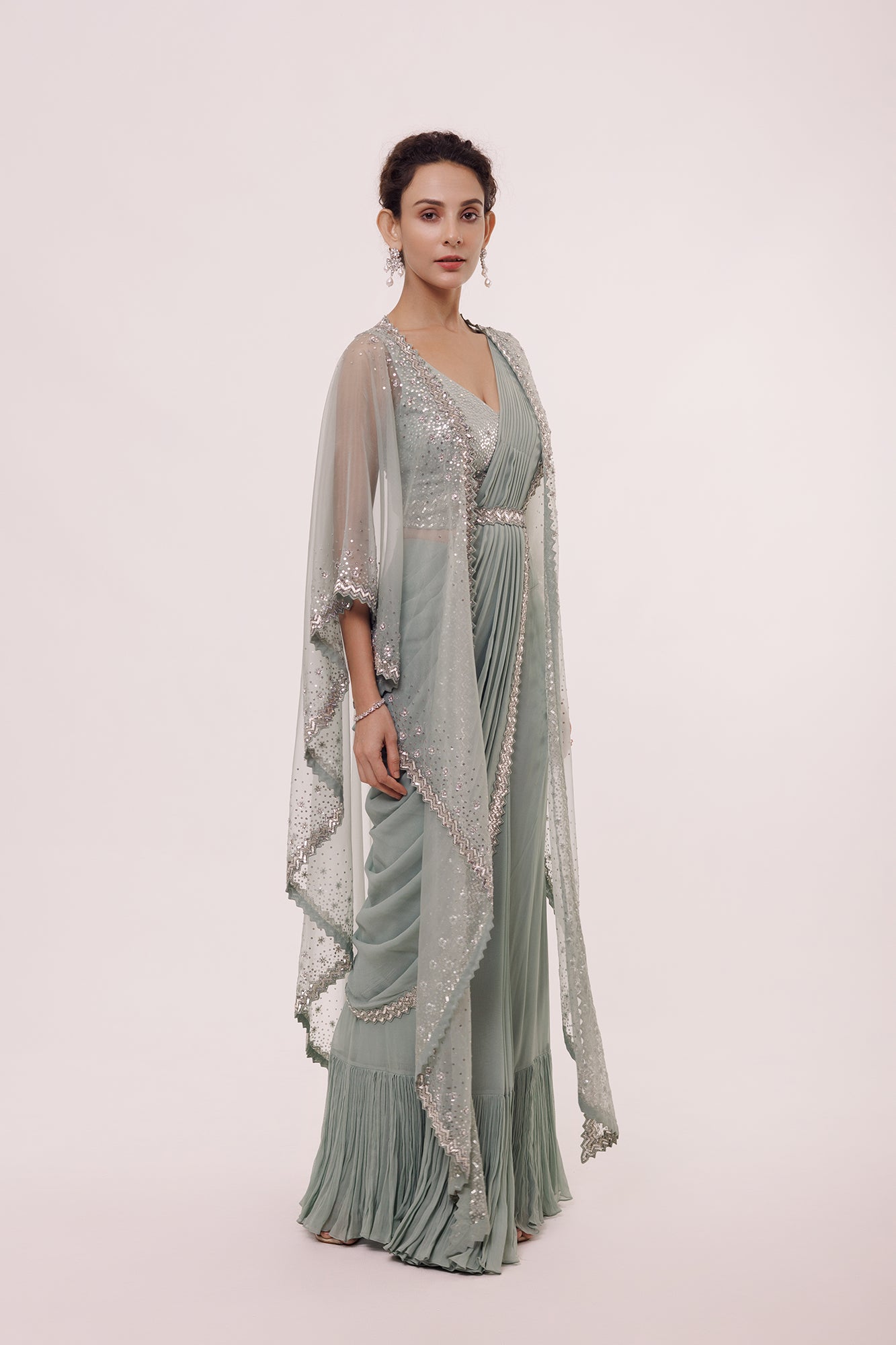 Shop an aqua green saree with embroidered edges and net cape. Make a fashion statement on festive occasions and weddings with designer sarees, designer suits, Indian dresses, Anarkali suits, palazzo suits, designer gowns, sharara suits, and embroidered sarees from Pure Elegance Indian fashion store in the USA.
