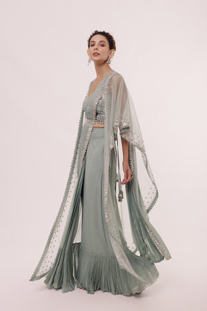 Shop an aqua green saree with embroidered edges and net cape. Make a fashion statement on festive occasions and weddings with designer sarees, designer suits, Indian dresses, Anarkali suits, palazzo suits, designer gowns, sharara suits, and embroidered sarees from Pure Elegance Indian fashion store in the USA.