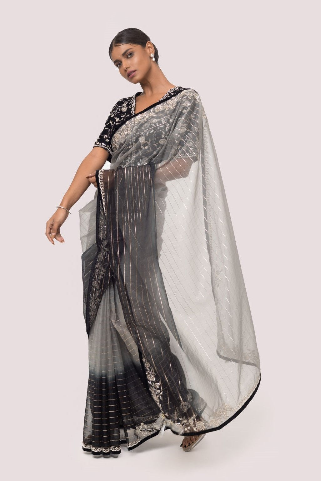 Shop grey and black dual saree set with an embroidered black blouse. Make a fashion statement on festive occasions and weddings with designer sarees, designer suits, Indian dresses, Anarkali suits, palazzo suits, designer gowns, sharara suits, and embroidered sarees from Pure Elegance Indian fashion store in the USA.
