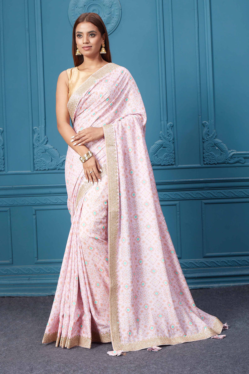 Shop beautiful powder pink printed crepe sari online in USA with embroidered border. Look royal at weddings and festive occasions in exquisite designer sarees, handwoven sarees, pure silk saris, Banarasi sarees, Kanchipuram silk sarees from Pure Elegance Indian saree store in USA. -full view