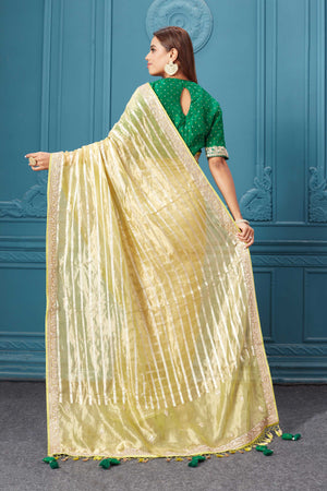 Buy yellow tissue Kora silk saree online in USA with green saree blouse. Look royal at weddings and festive occasions in exquisite designer sarees, handwoven sarees, pure silk saris, Banarasi sarees, Kanchipuram silk sarees from Pure Elegance Indian saree store in USA. -back