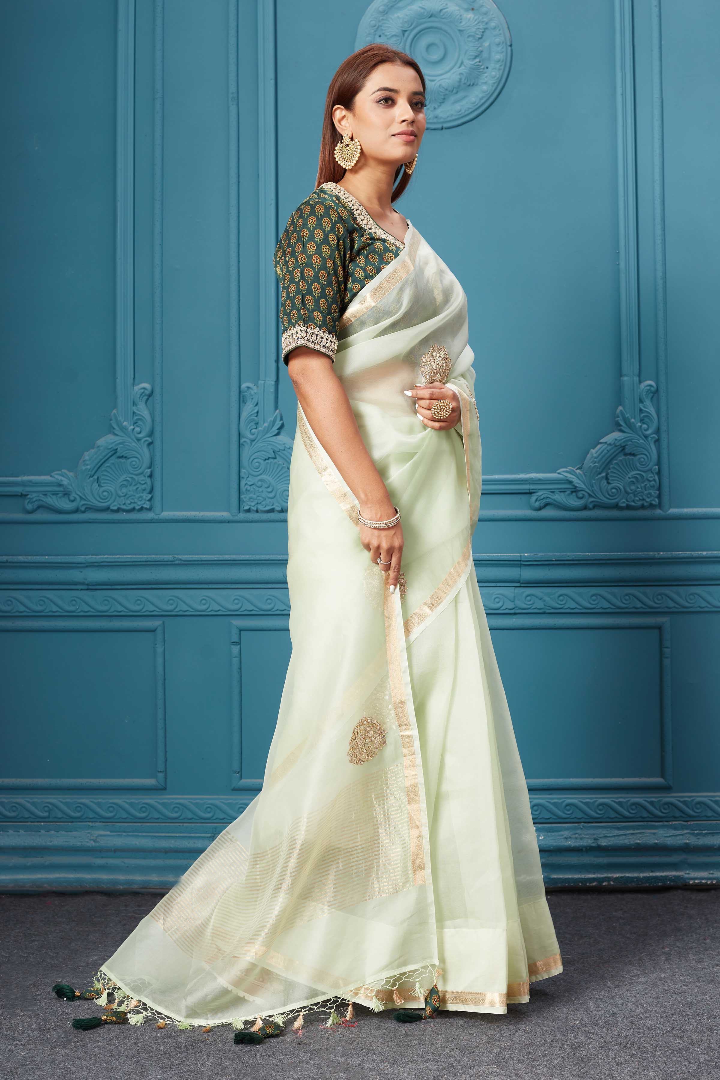 Buy mint green emrbroidered organza silk sari online in USA with blouse. Look royal at weddings and festive occasions in exquisite designer sarees, handwoven sarees, pure silk saris, Banarasi sarees, Kanchipuram silk sarees from Pure Elegance Indian saree store in USA. -side