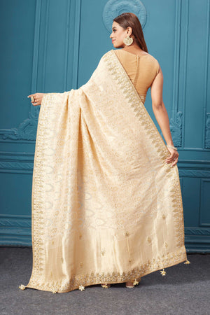 Shop cream Mashru Banarasi saree online in USA with embroidery. Look royal at weddings and festive occasions in exquisite designer sarees, handwoven sarees, pure silk saris, Banarasi sarees, Kanchipuram silk sarees from Pure Elegance Indian saree store in USA. -back