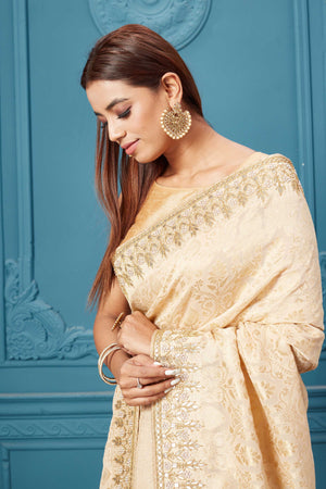 Shop cream Mashru Banarasi saree online in USA with embroidery. Look royal at weddings and festive occasions in exquisite designer sarees, handwoven sarees, pure silk saris, Banarasi sarees, Kanchipuram silk sarees from Pure Elegance Indian saree store in USA. -closeup