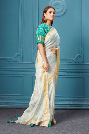 Buy beautiful white tissue silk saree online in USA with green embroidered blouse. Look royal at weddings and festive occasions in exquisite designer sarees, handwoven sarees, pure silk saris, Banarasi sarees, Kanchipuram silk sarees from Pure Elegance Indian saree store in USA. -side