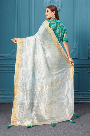 Buy beautiful white tissue silk saree online in USA with green embroidered blouse. Look royal at weddings and festive occasions in exquisite designer sarees, handwoven sarees, pure silk saris, Banarasi sarees, Kanchipuram silk sarees from Pure Elegance Indian saree store in USA. -back