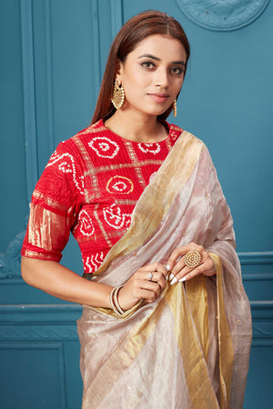 Shop pink tissue silk saree online in USA with red bandhej blouse. Look royal at weddings and festive occasions in exquisite designer sarees, handwoven sarees, pure silk saris, Banarasi sarees, Kanchipuram silk sarees from Pure Elegance Indian saree store in USA. -closeup