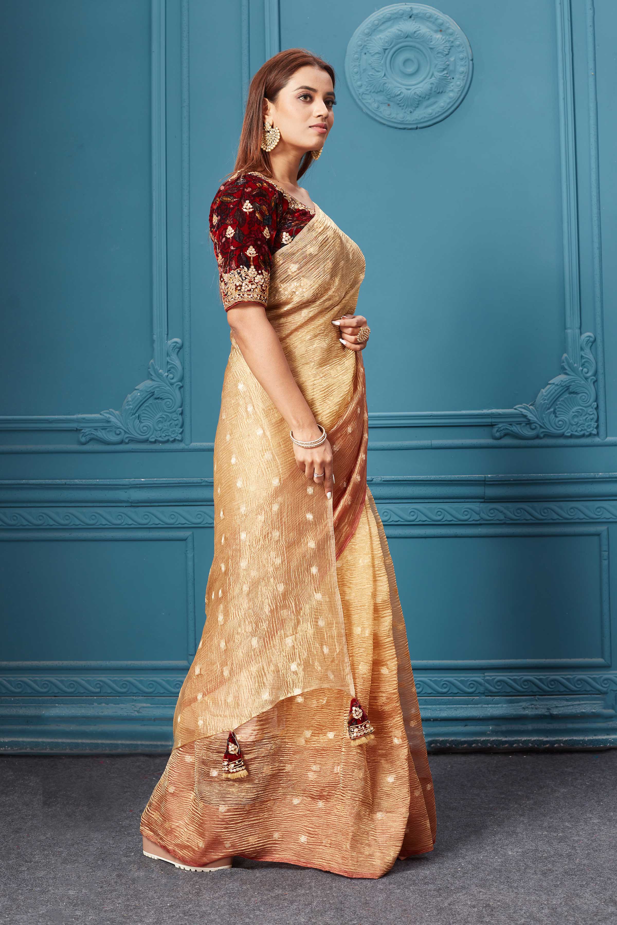 Buy golden tissue saree online in USA with velvet embroidered blouse. Look royal at weddings and festive occasions in exquisite designer sarees, handwoven sarees, pure silk saris, Banarasi sarees, Kanchipuram silk sarees from Pure Elegance Indian saree store in USA. -side