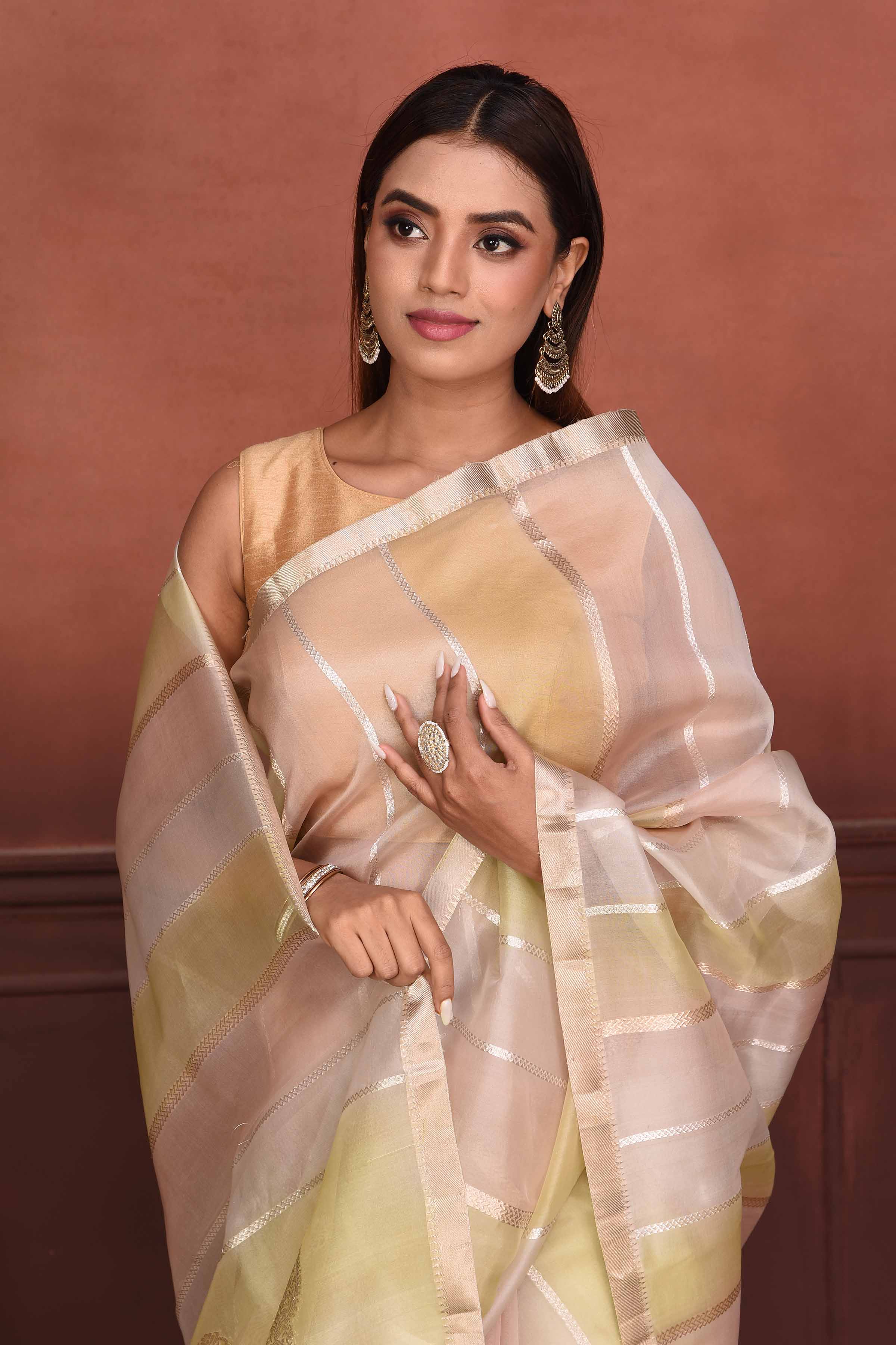 Shop yellow and peach striped zari organza Banarasi saree online in USA. Look your best on festive occasions in latest designer sarees, pure silk sarees, Kanchipuram silk sarees, handwoven sarees, tussar silk sarees, embroidered sarees from Pure Elegance Indian clothing store in USA.-closeup