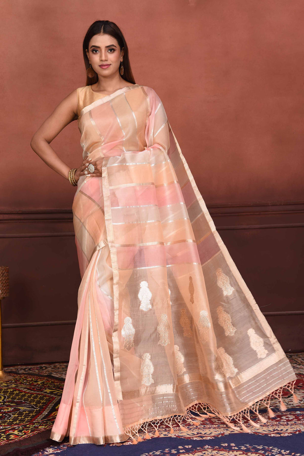 Shop beautiful peach and pink striped zari organza Banarasi saree online in USA. Look your best on festive occasions in latest designer sarees, pure silk sarees, Kanchipuram silk sarees, handwoven sarees, tussar silk sarees, embroidered sarees from Pure Elegance Indian clothing store in USA.-full view