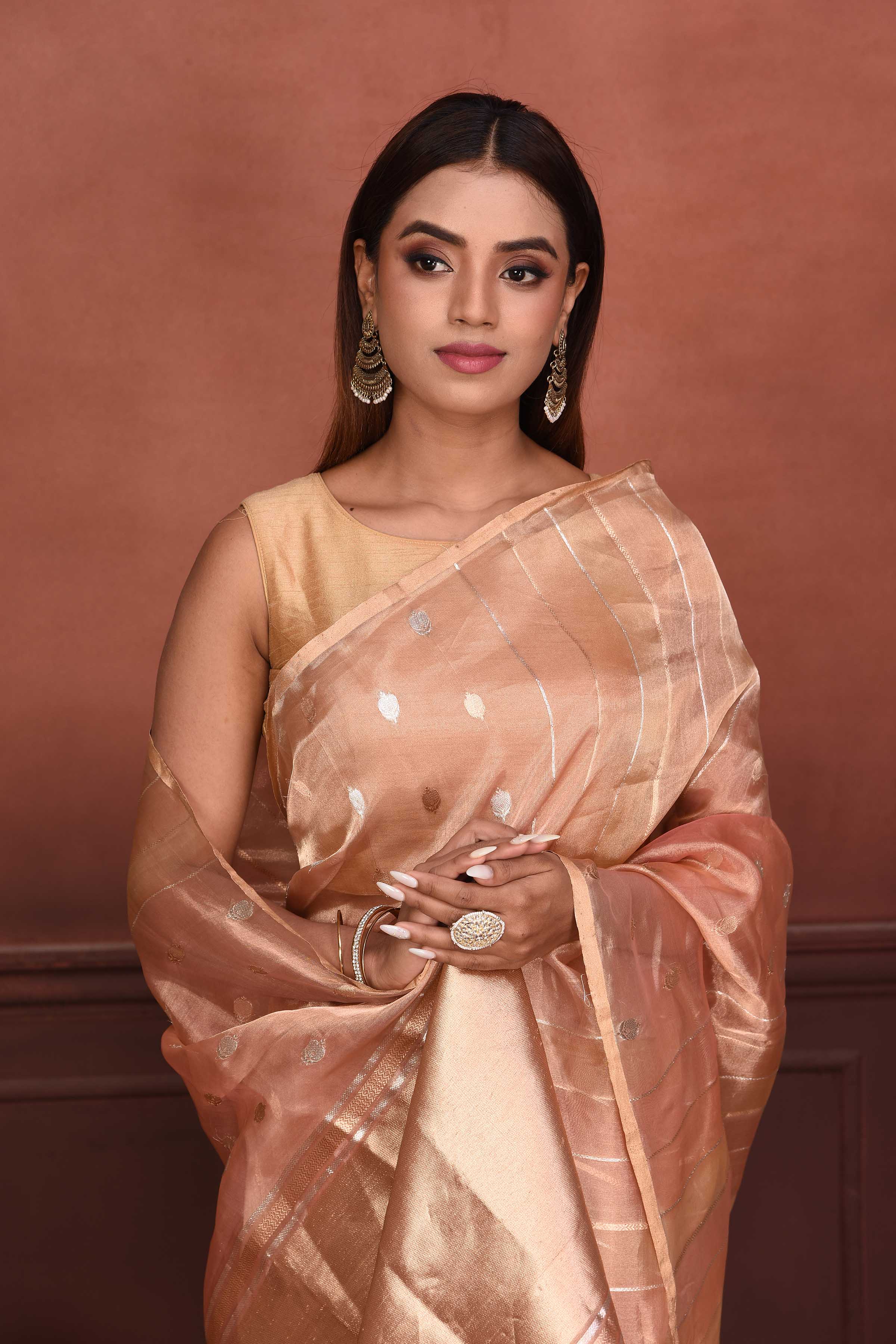 Shop peach zari stripes organza Banarasi saree online in USA with buta. Look your best on festive occasions in latest designer sarees, pure silk sarees, Kanchipuram silk sarees, handwoven sarees, tussar silk sarees, embroidered sarees from Pure Elegance Indian clothing store in USA.-closeup