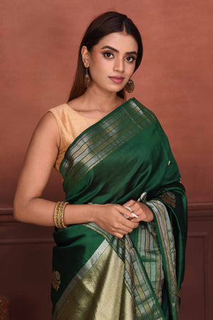 Buy bottle green Katan silk Banarasi saree online in USA with floral buta. Look your best on festive occasions in latest designer sarees, pure silk sarees, Kanchipuram silk sarees, handwoven sarees, tussar silk sarees, embroidered sarees from Pure Elegance Indian clothing store in USA.-closeup