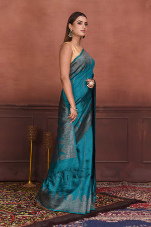 Buy beautiful teal tussar Banarasi saree online in USA with antique zari border. Look your best on festive occasions in latest designer sarees, pure silk sarees, Kanchipuram silk sarees, handwoven sarees, tussar silk sarees, embroidered sarees from Pure Elegance Indian clothing store in USA.-side