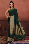 Shop bottle green crepe Banarasi saree online in USA with zari border. Look your best on festive occasions in latest designer sarees, pure silk sarees, Kanchipuram silk sarees, handwoven sarees, tussar silk sarees, embroidered sarees from Pure Elegance Indian clothing store in USA.-full view