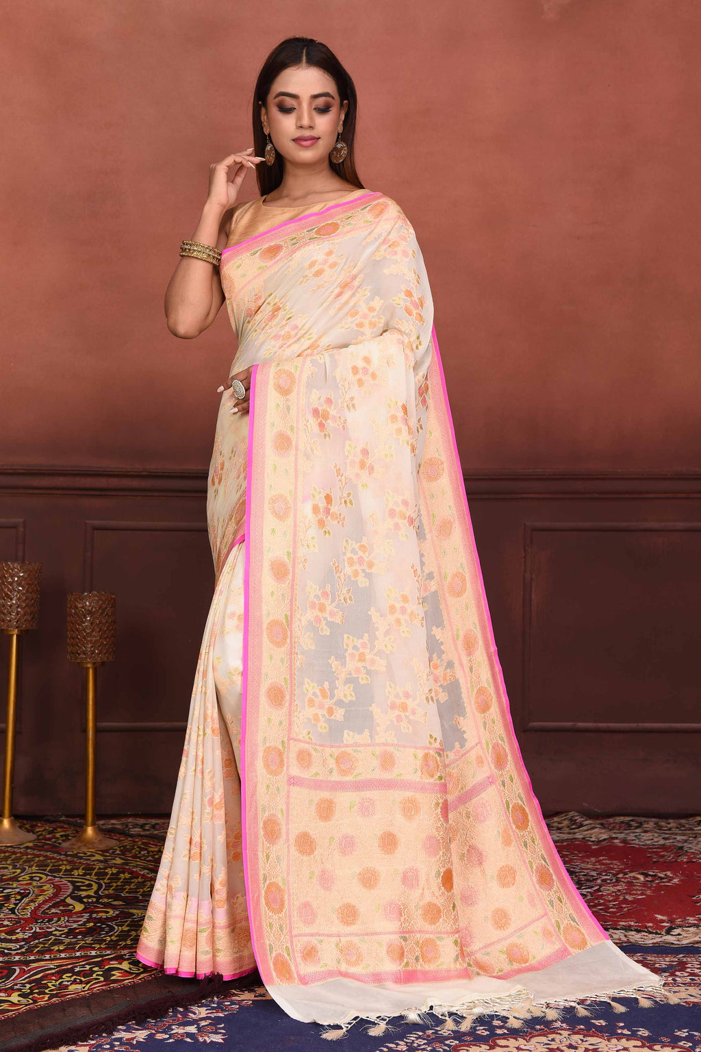 Shop cream georgette Banarasi saree online in USA with floral zari work. Look your best on festive occasions in latest designer sarees, pure silk sarees, Kanchipuram silk sarees, handwoven sarees, tussar silk sarees, embroidered sarees from Pure Elegance Indian clothing store in USA.-full view