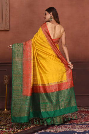 Shop yellow tussar Banarasi saree online in USA with red green zari border. Look your best on festive occasions in latest designer sarees, pure silk sarees, Kanchipuram silk sarees, handwoven sarees, tussar silk sarees, embroidered sarees from Pure Elegance Indian clothing store in USA.-back