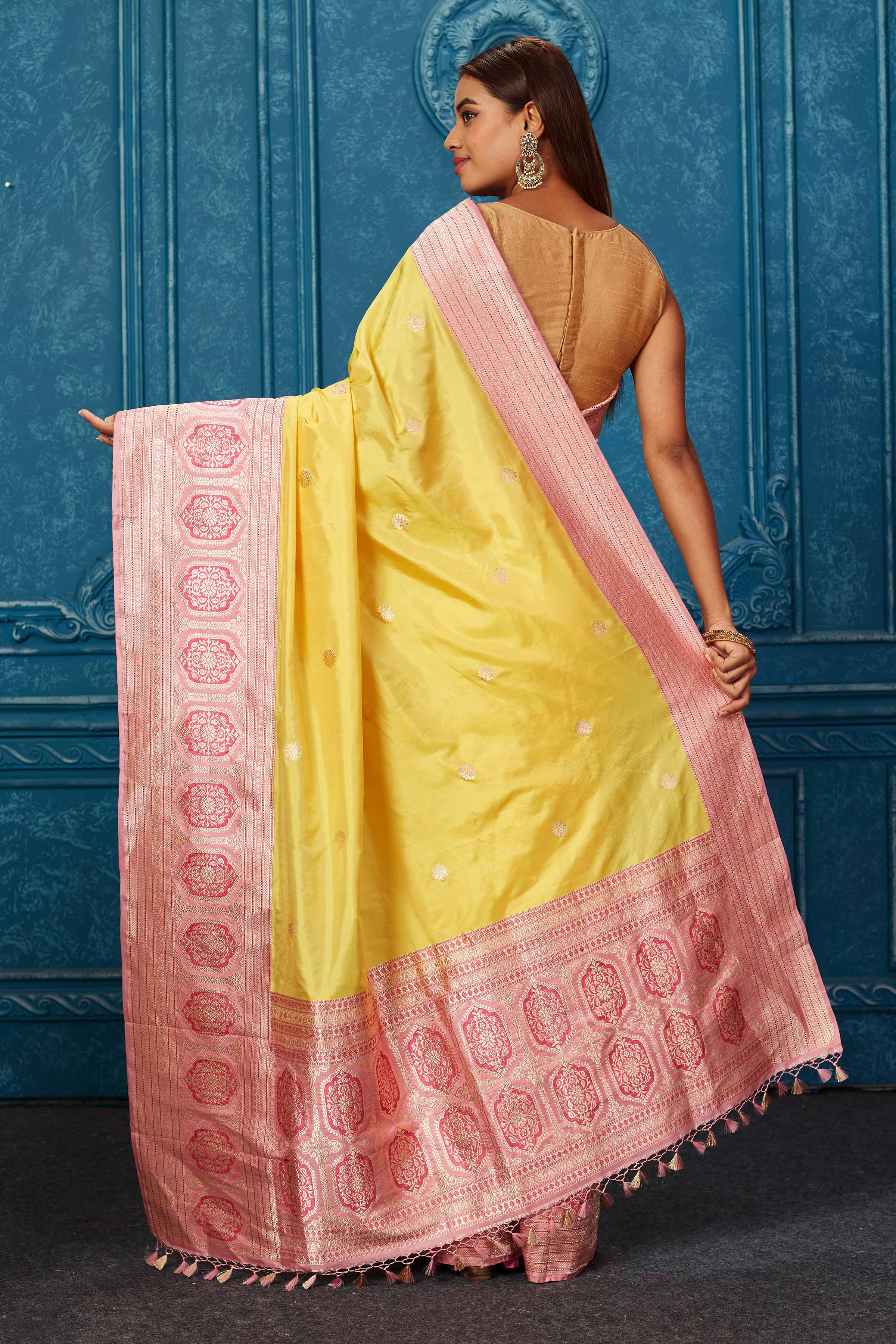 Shop yellow Banarasi saree online in USA with pink zari border. Look your best on festive occasions in latest designer sarees, pure silk saris, Kanchipuram silk sarees, handwoven sarees, tussar silk sarees, embroidered sarees from Pure Elegance Indian saree store in USA.-back