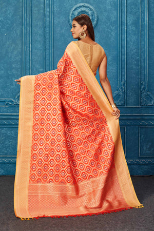 Shop beautiful orange Banarasi saree online in USA with zari minakari jaal. Look your best on festive occasions in latest designer sarees, pure silk saris, Kanchipuram silk sarees, handwoven sarees, tussar silk sarees, embroidered sarees from Pure Elegance Indian saree store in USA.-back