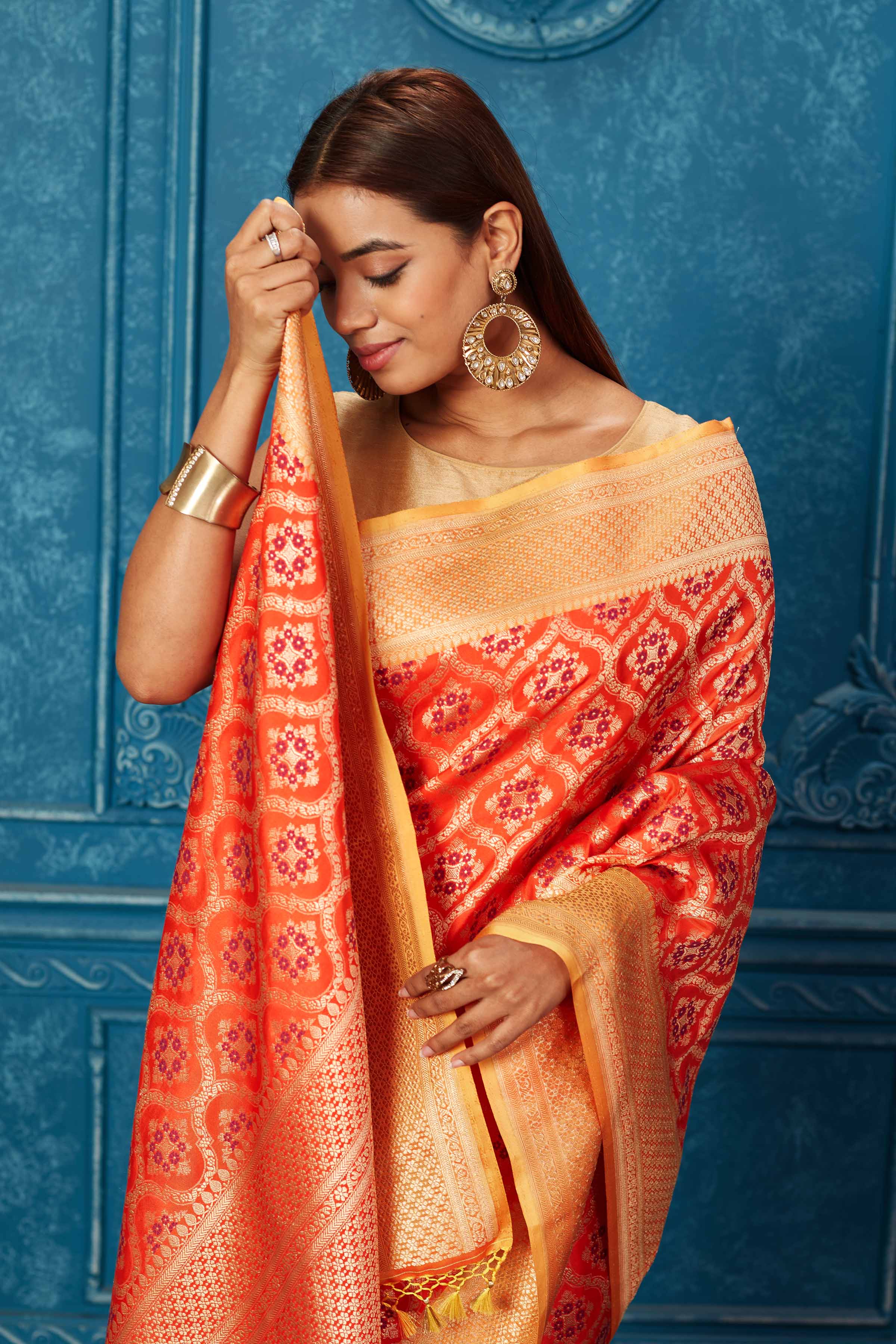 Shop beautiful orange Banarasi saree online in USA with zari minakari jaal. Look your best on festive occasions in latest designer sarees, pure silk saris, Kanchipuram silk sarees, handwoven sarees, tussar silk sarees, embroidered sarees from Pure Elegance Indian saree store in USA.-closeup