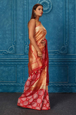 Shop golden Banarasi saree online in USA with red zari border. Look your best on festive occasions in latest designer sarees, pure silk saris, Kanchipuram silk sarees, handwoven sarees, tussar silk sarees, embroidered sarees from Pure Elegance Indian saree store in USA.-side