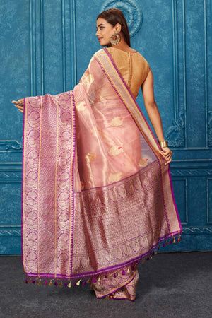 Buy golden pink Banarasi saree online in USA with purple zari border. Look your best on festive occasions in latest designer sarees, pure silk saris, Kanchipuram silk sarees, handwoven sarees, tussar silk sarees, embroidered sarees from Pure Elegance Indian saree store in USA.-back