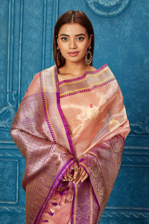 Buy golden pink Banarasi saree online in USA with purple zari border. Look your best on festive occasions in latest designer sarees, pure silk saris, Kanchipuram silk sarees, handwoven sarees, tussar silk sarees, embroidered sarees from Pure Elegance Indian saree store in USA.-closeup
