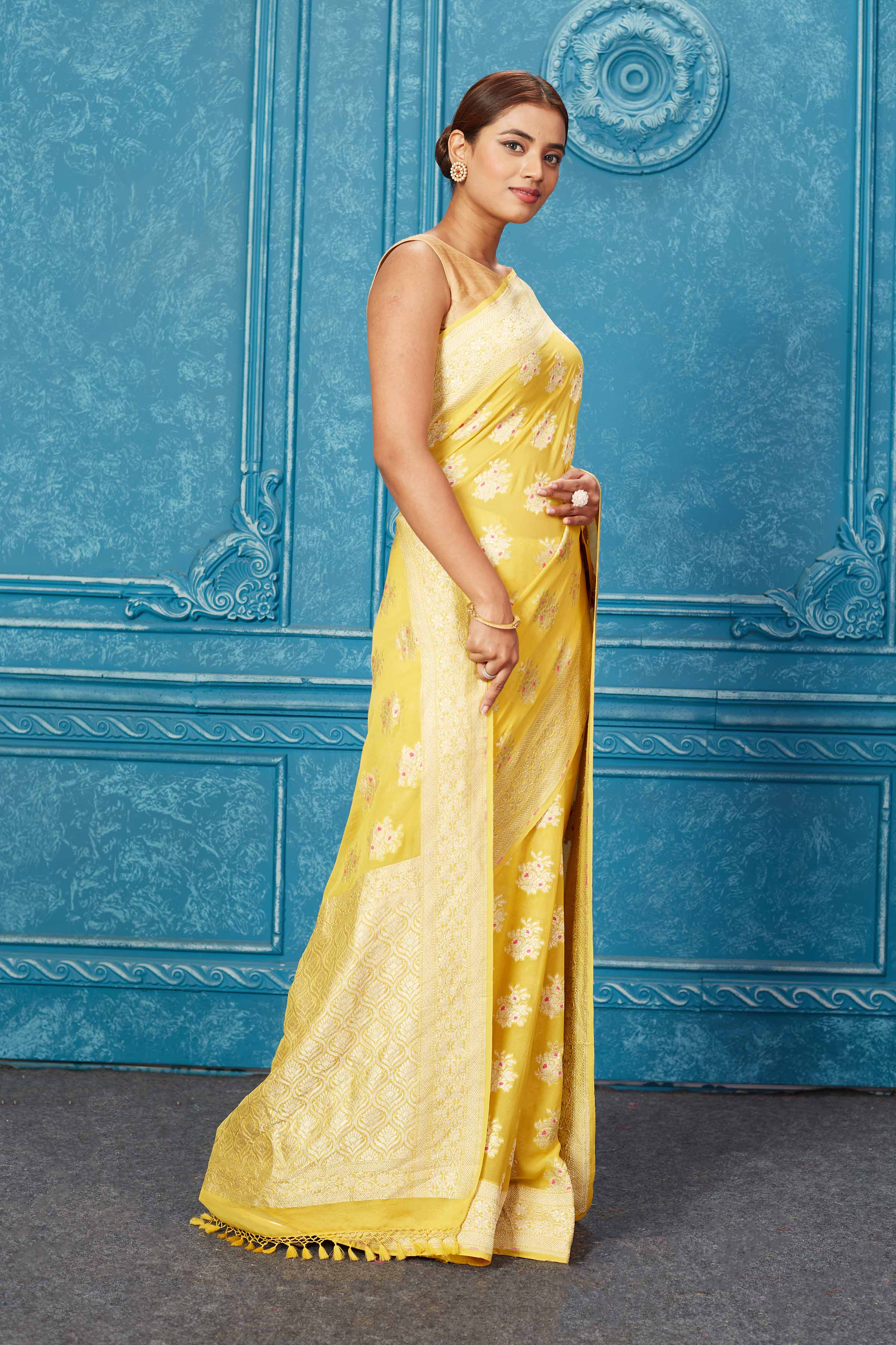 Shop beautiful yellow georgette Banarasi sari online in USA with zari minakari buta. Keep your ethnic wardrobe up to date with latest designer sarees, pure silk sarees, Kanchipuram silk sarees, handwoven sarees, tussar silk sarees, embroidered sarees from Pure Elegance Indian saree store in USA.-side