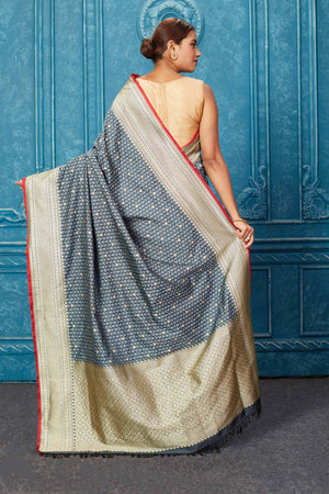 Shop grey Mashru Banarasi saree online in USA with zari border.  Keep your ethnic wardrobe up to date with latest designer sarees, pure silk sarees, Kanchipuram silk sarees, handwoven sarees, tussar silk sarees, embroidered sarees from Pure Elegance Indian saree store in USA.-back
