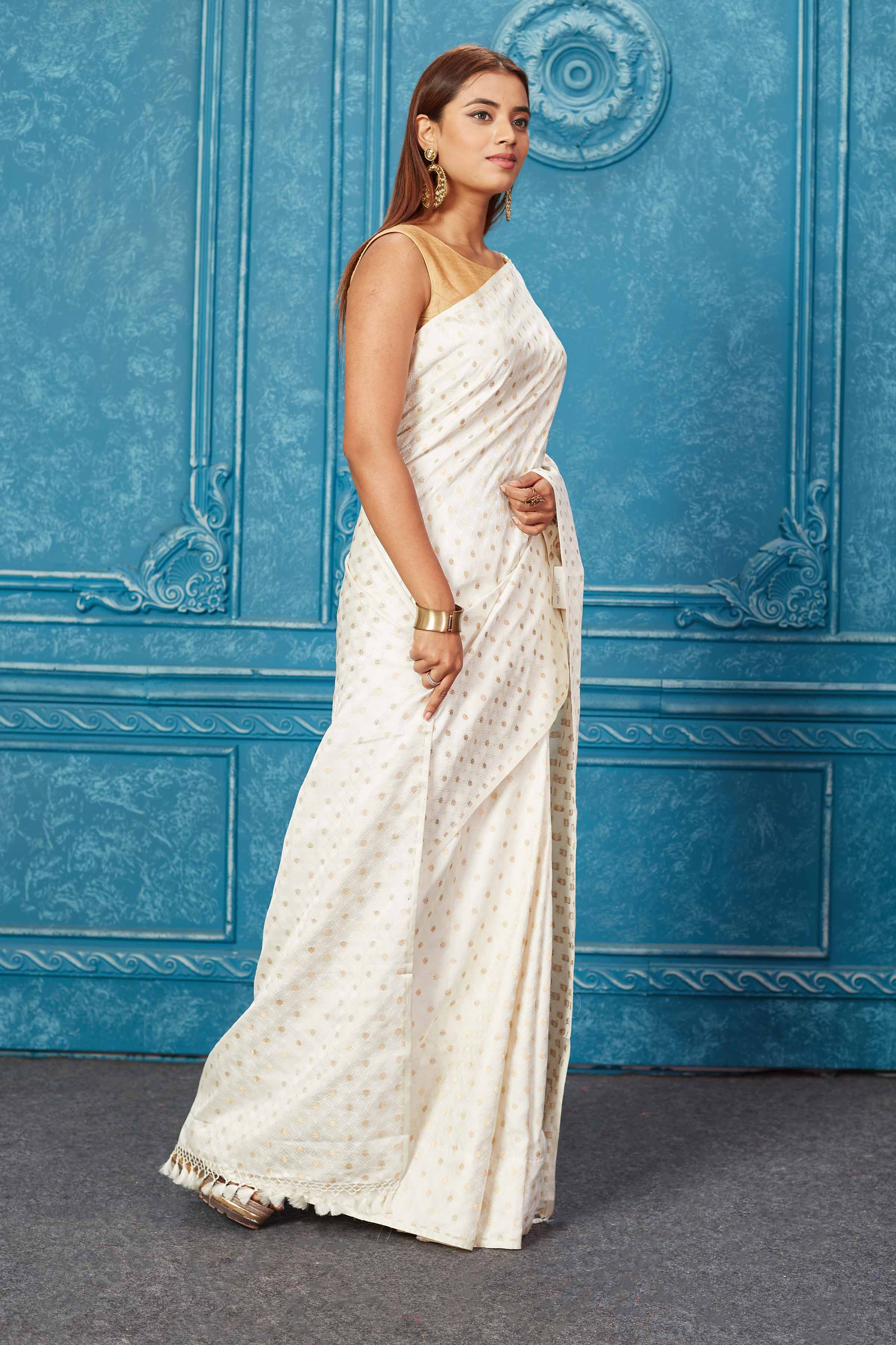 Shop white Banarasi silk sari online in USA with overall buta. Keep your ethnic wardrobe up to date with latest designer sarees, pure silk sarees, Kanchipuram silk sarees, handwoven sarees, tussar silk sarees, embroidered sarees from Pure Elegance Indian saree store in USA.-side