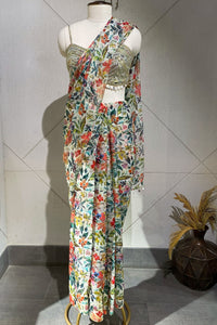 Shop a beautiful off-white georgette saree featuring floral work. Make a fashion statement on festive occasions and weddings with designer sarees, designer suits, Indian dresses, Anarkali suits, palazzo suits, designer gowns, sharara suits, and embroidered sarees from Pure Elegance Indian fashion store in the USA.